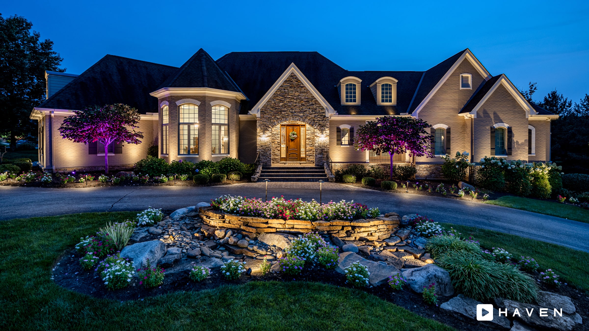 Warm-white permanent lighting across a detailed residential roofline